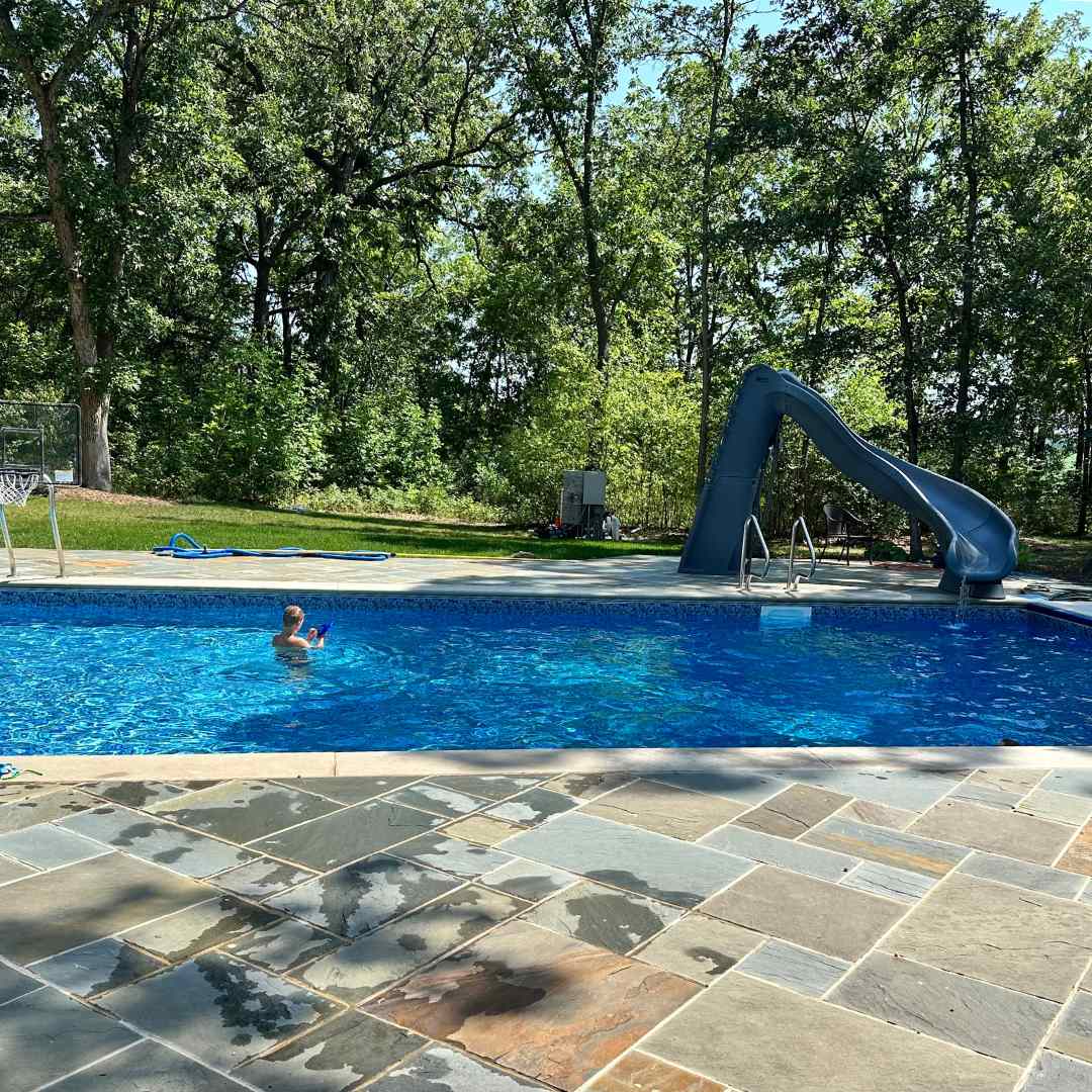 Child swimming in a pool installed by a pool installer in Waterford, Wisconsin.