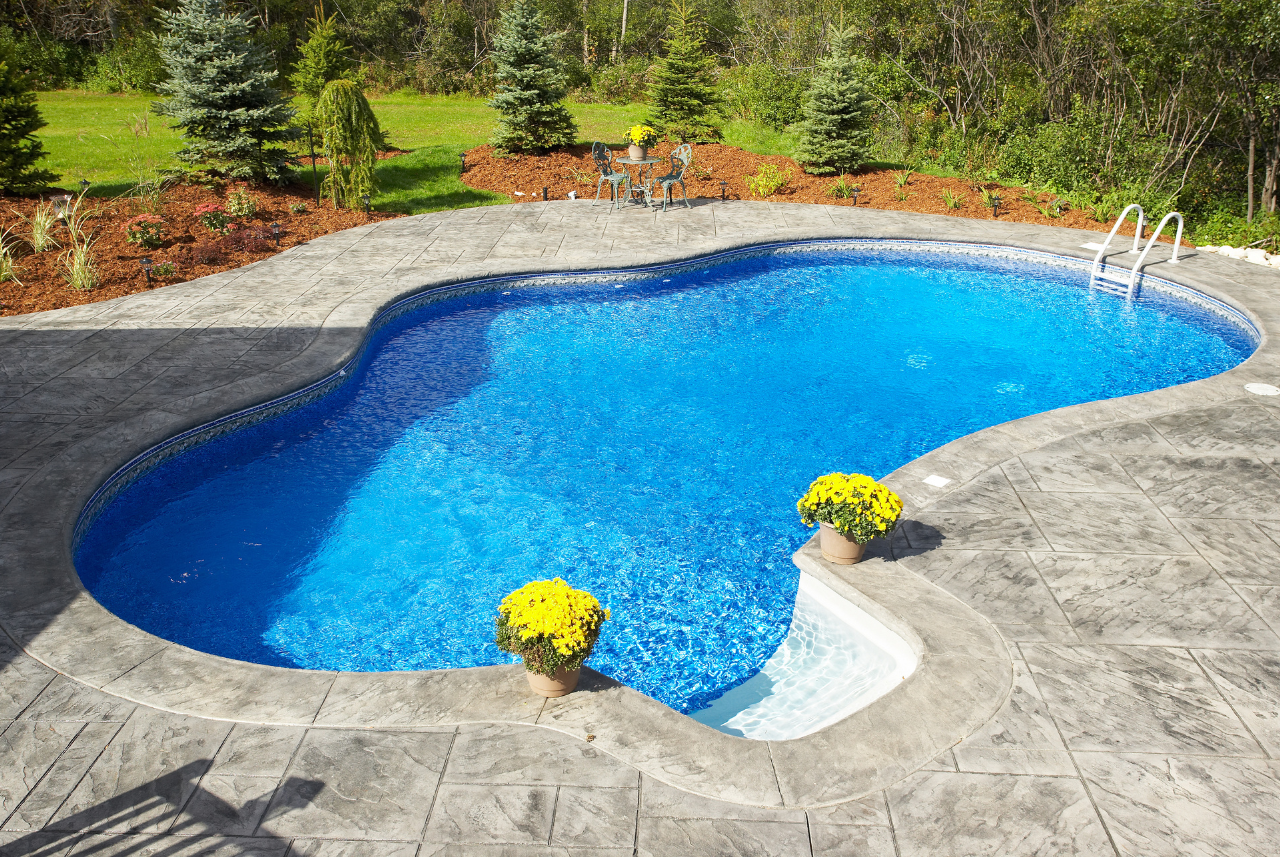 A custom pool and landscape in waterford, wi, designed by Loomis Pools.