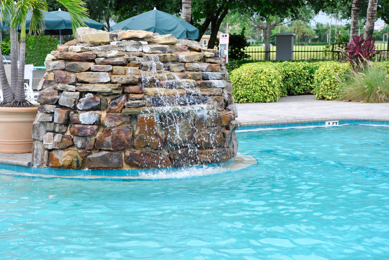 Design Your Own Swimming Pool with a natural stone waterfall in Waterford, WI.