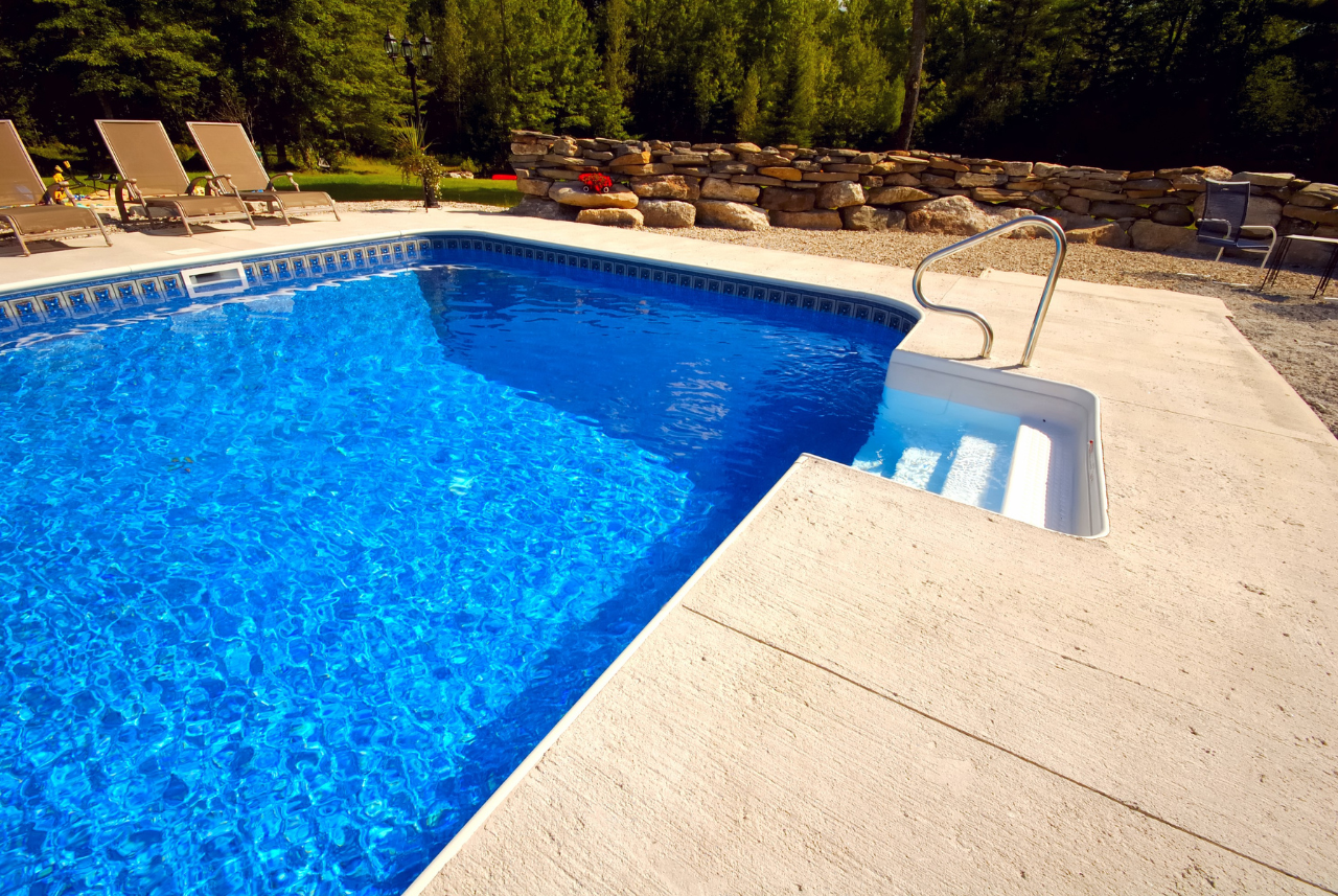 Custom Swimming Pool Contractor creates a backyard pool with seating area in SE Wisconsin