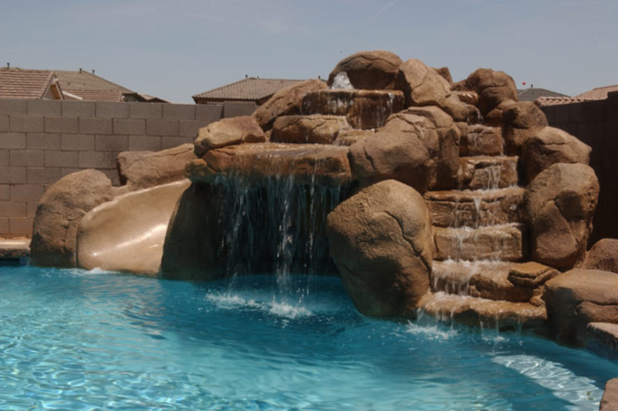 custom designed inground pool with rock slide