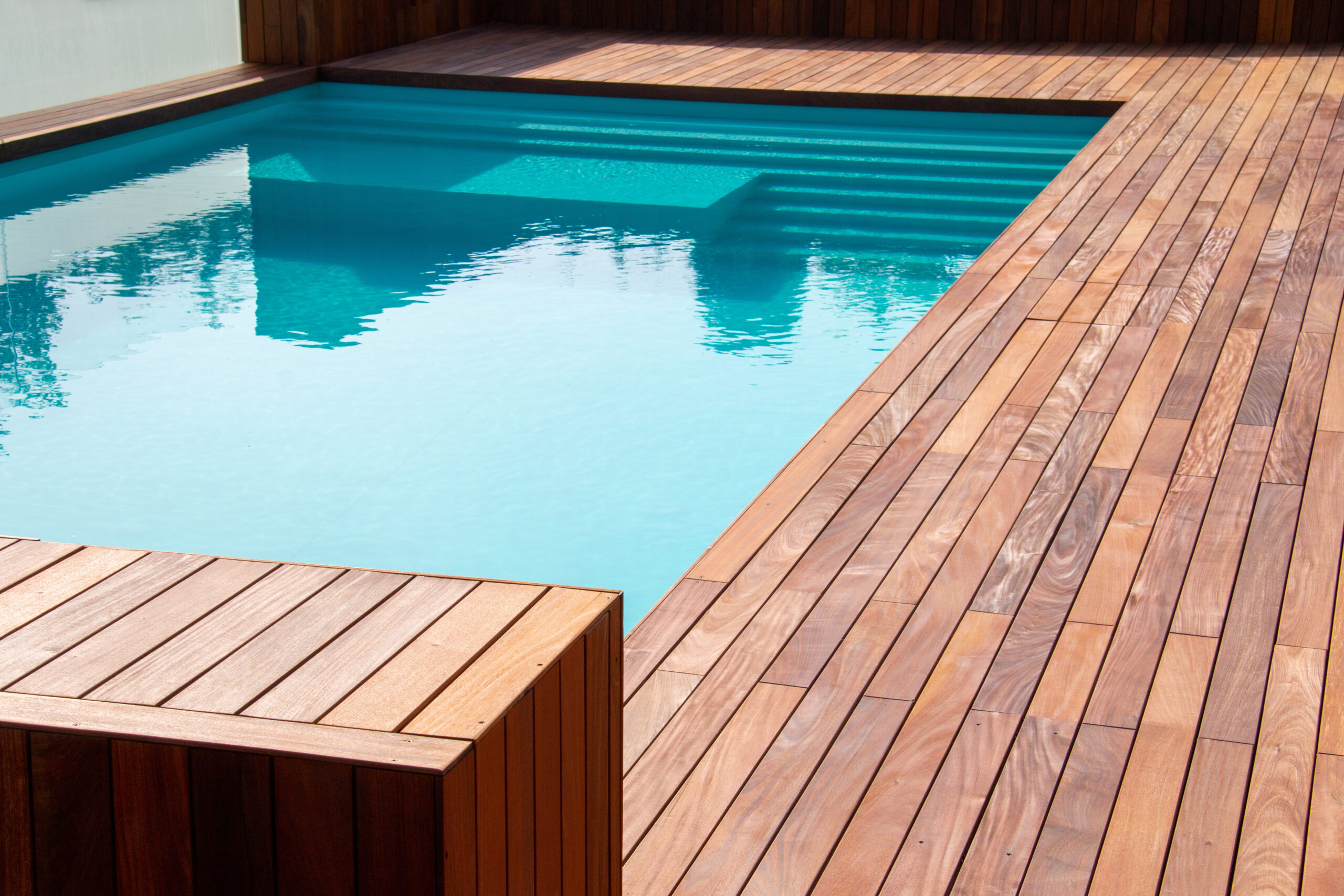 Hardwood ipe pool deck on direct sun heat, summer swimming pool